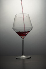 red wine pouring into glass