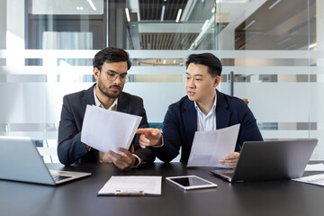 Business meeting conference, discussion. Two men investors financiers discussing paper reports of...