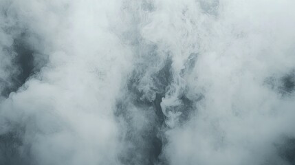 Fototapeta premium Abstract image of swirling white smoke against a dark background.