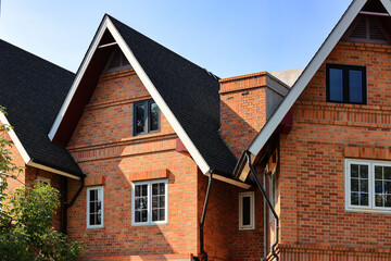 Building made of brick facade with beautiful white wooden windows.