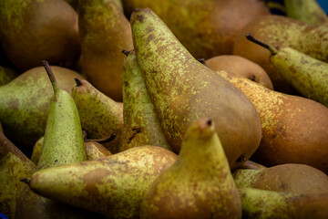 A full frame photograph of pears for sale on a market stall