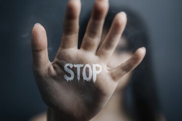 Woman in fear: protective pose, rescue gesture, stop abuse, domestic violence awareness, safety message, defense stance, empowerment call, prevention campaign, emotional strength.