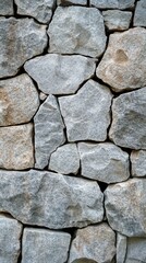 Obraz premium Rustic stone wall texture with natural rough finish and various rock sizes