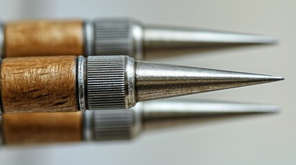 Naklejka premium Metal tips of wood-handled tools on light background.
