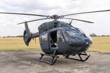 Gray painted modern H145M military transport helicopter stationary on the ground