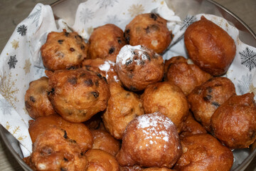 Oliebollen fresh Dutch pastry in a bowl. New years treat in the Netherlands. Happy New Year snack.