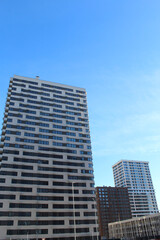 Fototapeta premium new apartment building in city, facade of new buildings,modern office building with sky