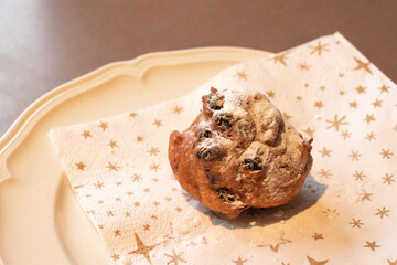Oliebol fresh Dutch pastry on plate festive tissue. New years treat in the Netherlands. Happy New Year snack.