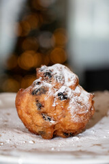 Oliebol fresh Dutch pastry on plate festive tissue. New years treat in the Netherlands. Happy New Year snack.