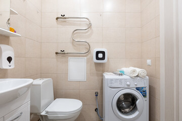 modern bathroom room with toilet and washing machine