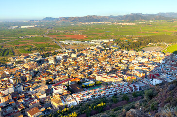 Fototapeta premium Town with Buildings, houses, streets. City building, aerial view. View of rooftops, streets of Almenara, Spain. Roofs of houses, drone view. Mountains landscape. Urban rooftop. Typical spanish city