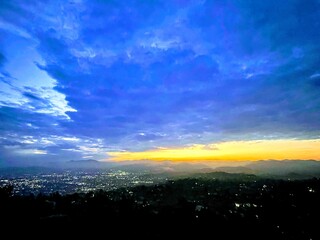 Dramatic Sunrise Over Stormy Valley Sky