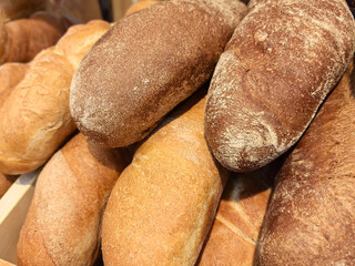 Freshly baked artisan bread displayed at a bustling market stall