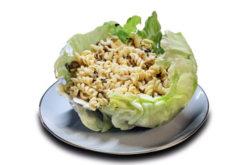 Macaroni with minced meat and mushrooms served in cabbage