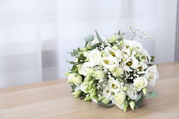 Beautiful wedding bouquet on wooden table, space for text