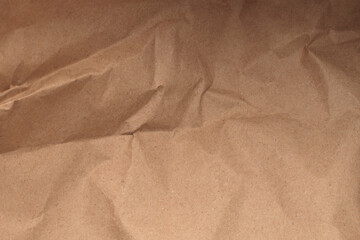 Beige brown crumpled package old craft paper blank. Light and shadow texture copy space background.