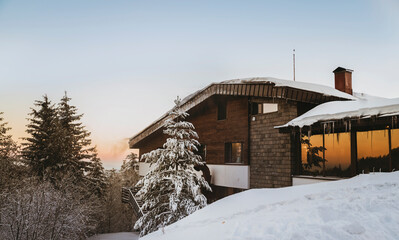 Fototapeta premium Wooden chalet hut in the winter forest 