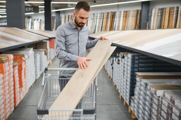 man choosing laminate samples in hardware store