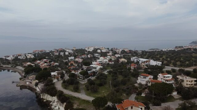 Calm aegean sea beach and coastal houses of sakran town of turkey, aerial view