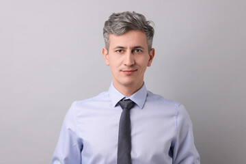 Portrait of businessman on light grey background