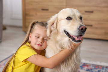 Girl with her cute Golden Retriever dog at home