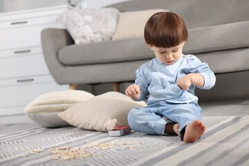 Little boy playing with matches at home. Child in danger