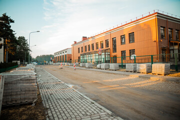 Construction Site Near Modern Two Story Building with Roadwork