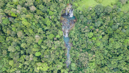 Top view of a landscape surrounded by nature with the Nauyacas Waterfalls of the Baru River in the middle of the green tropical forest in Costa Rica