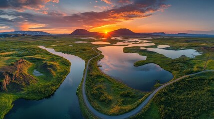 A long, twisting road across a breathtaking volcanic scenery at sunset in Myvatn, Iceland 