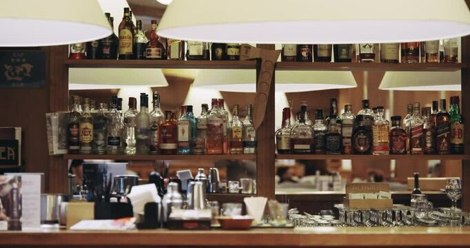 Bansko, Bulgaria - 17 Feb, 2024: Interior view of a stylish pub bar featuring a well-stocked shelves with a variety of whiskey bottles, reflecting an inviting atmosphere for social gatherings.