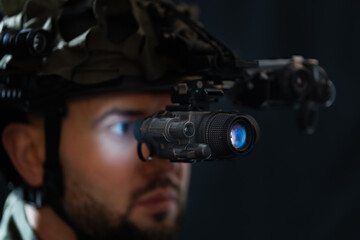 A modern soldier using night vision and thermal imaging in the darkness.