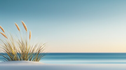   A blade of grass emerges from the snow before a tranquil body of water surrounded by azure sky
