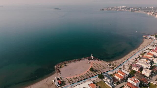 Calm aegean sea beach and coastal houses of sakran town of turkey, aerial view