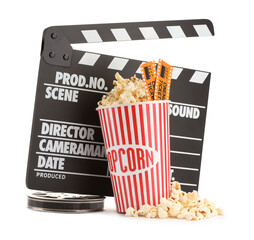 Tasty popcorn, clapper, film reel and movie tickets isolated on white