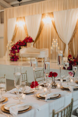 Luxurious Wedding Reception Table Decor with Floating Candles, Red Roses, and Gold Accents