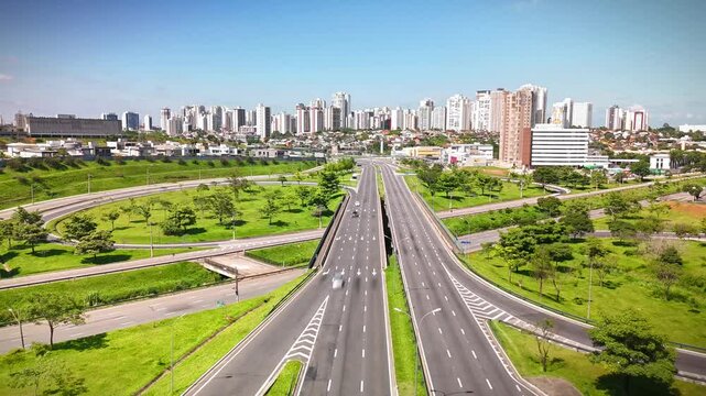 aerial view of a highway in Sao Jose dos Campos, mid size city in Sao Paulo state, Brazil with the city skyline in the background