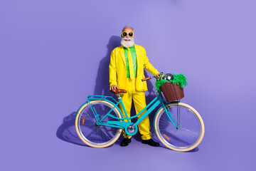 Photo of cheerful grandfather fashionable man dressed yellow stylish clothes traveling bicycle...