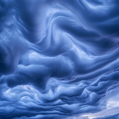 Obraz premium Dramatic Swirling Blue Clouds under Soft Evening Light in Sky