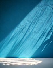 Palm leaves shadow on blue wall background and pastel floor. Summer tropical beach background. Empty room for product presentation. Minimal concept.
