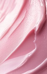 Close-up of smooth, light pink cream or lotion with flowing texture.