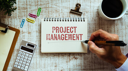 There is notebook with the word Project Management. It is as an eye-catching image.