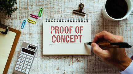 There is notebook with the word Proof of Concept. It is as an eye-catching image.