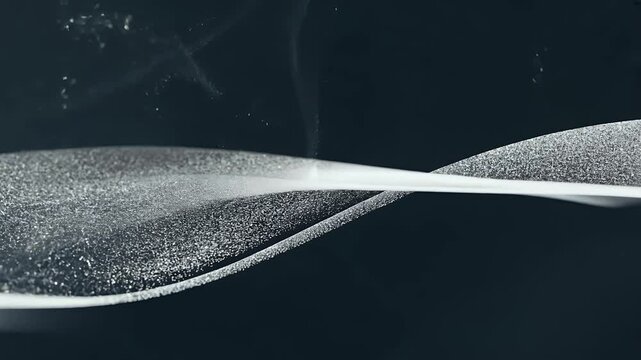 Elegant curved silver lines shimmer black backdrop creating intricate looping animation fine particles dynamic depth effects