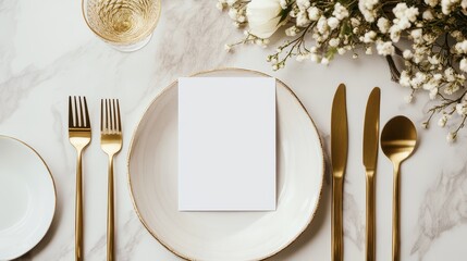 Elegant table setting featuring a blank card mockup, gold cutlery, and floral decor, perfect for weddings or special events.