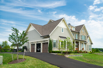 modern family house with big lawn in the foreground, summer day blue sky.