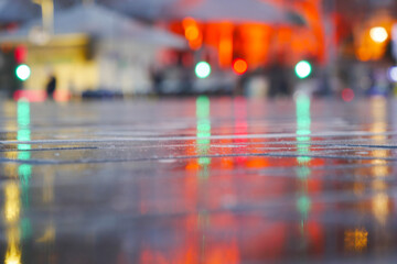 Captivating and Vibrant Reflections on Wet Pavement Under the Night Sky