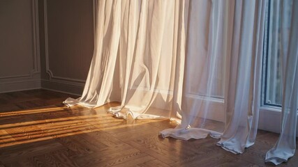 Sunlit room with flowing curtains and wooden floor, serene ambiance. Home interior and tranquility concept