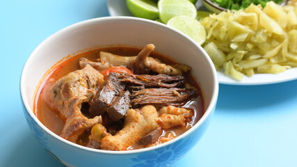 rice vermicelli with northern thai curry sauce on blue background
