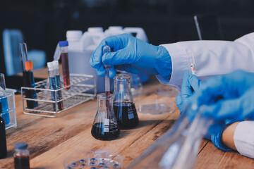 Blood test in the laboratory. Laboratory assistant working with the dispenser. Vacuum tubes with...