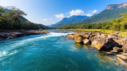 Serene River Flowing Through Lush Mountains Under Clear Blue Sky